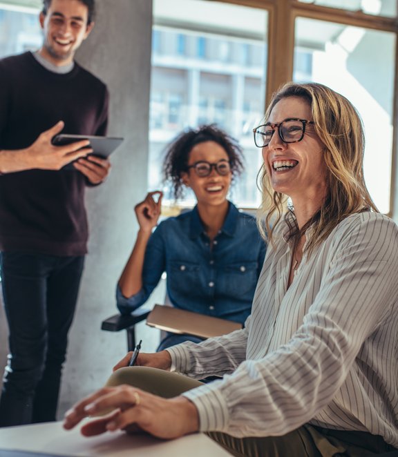 Colleagues-laughing-next-to-window