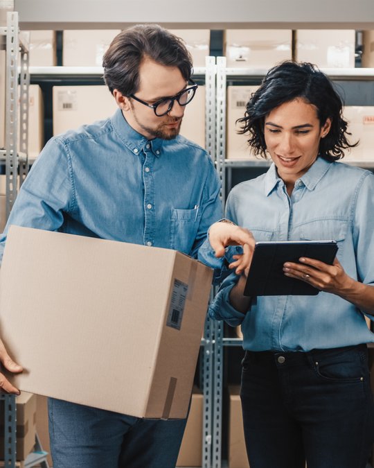 Colleagues discussing integrations workflow with tablet in hands.