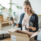 Consumer unpacking package sporting goods - weights - parcel - delivery